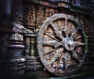 a large wheel on a stone wall