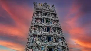 a large multi-tiered tirupati temple building with statues