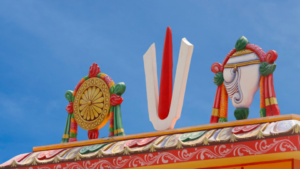 a colorful tirupati balaji sculpture on a roof